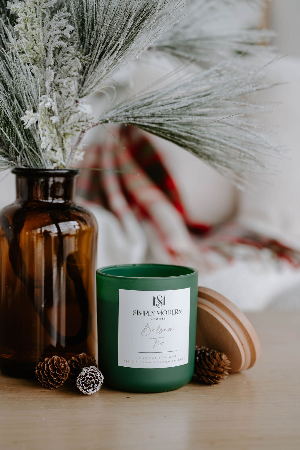 Balsam Fir olive green candle with the lid off showing the crackling wood wick and clean coconut soy wax
