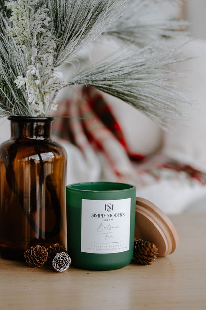 Balsam Fir olive green candle with the lid off showing the crackling wood wick and clean coconut soy wax