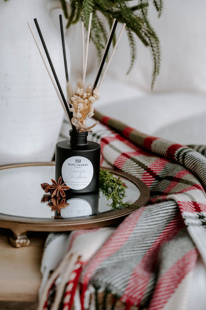 Home for Christmas black reed diffuser styled with star anise and winter greens