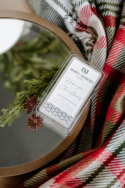 Home for Christmas 4 oz coconut soy wax melt clamshell on a mirrored tray with cedar, star anise and holiday plaid