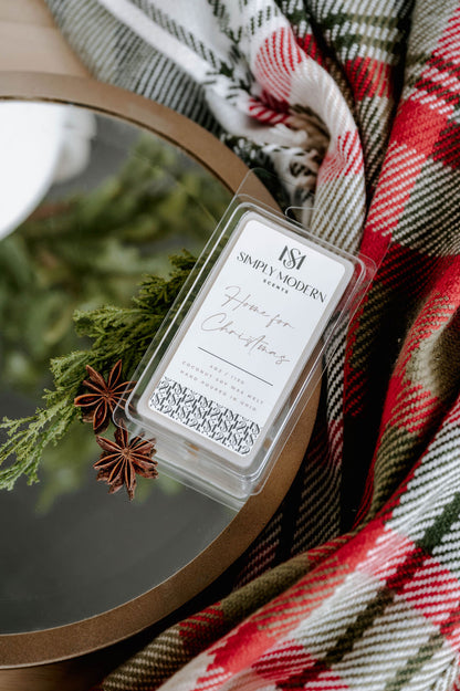 Overhead view of the Home for Christmas coconut soy wax melt with winter greenery