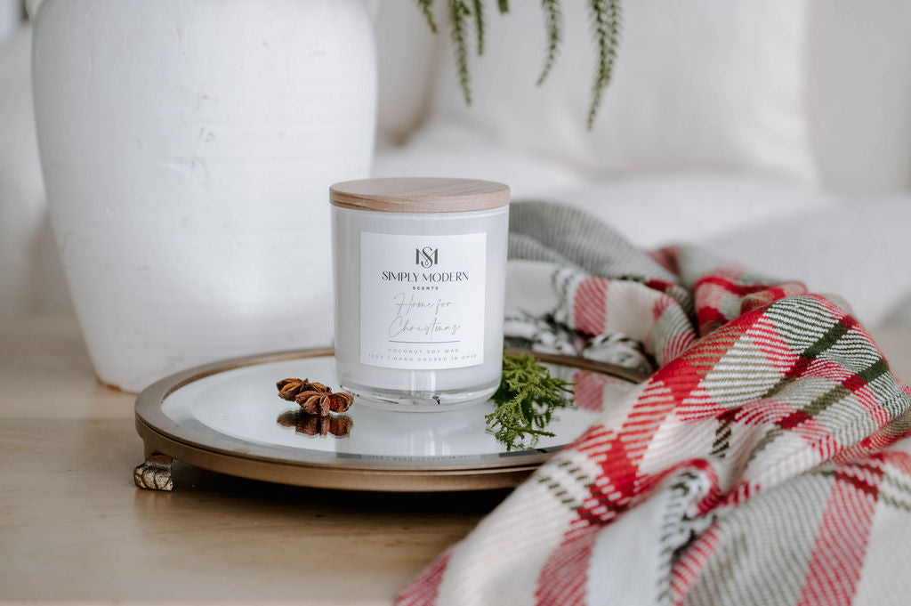 Home for Christmas white candle on a brass mirrored tray in a bright holiday living room