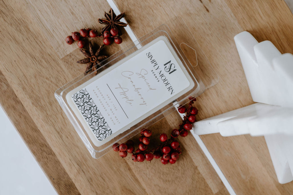 Overhead view of the Spiced Cranberry Apple coconut soy wax melt with berries and a marble tree