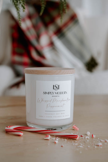Whipped Marshmallow Peppermint 12 oz wood-wick coconut soy candle in a white vessel with a wooden lid, styled with a crushed candy cane